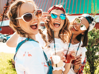 Three young beautiful smiling hipster girls in trendy summer clothes.Sexy carefree women posing...