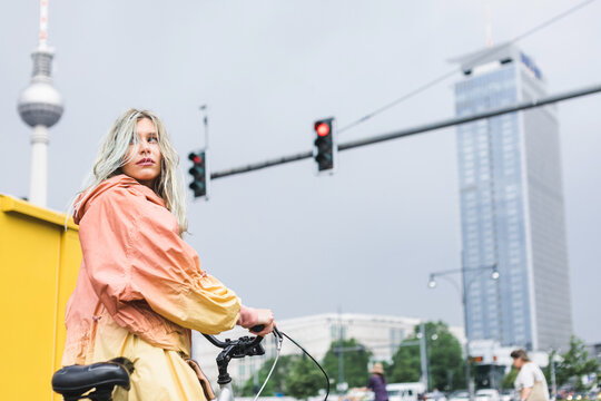 Blond riding bike through Berlin