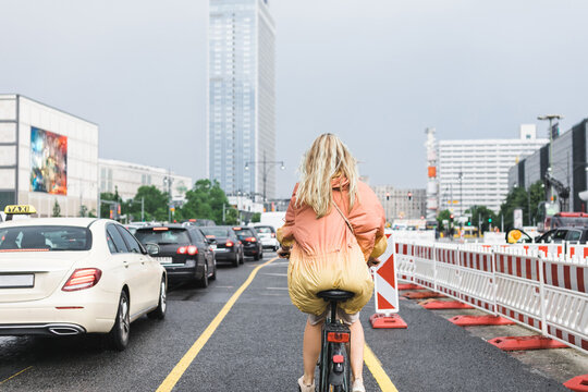 Blond riding bike through Berlin