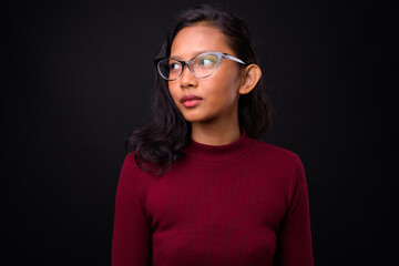 Portrait of young beautiful Asian businesswoman with eyeglasses