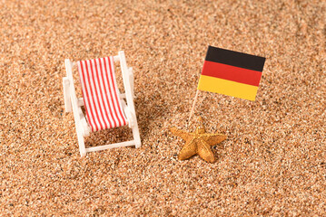 Sunbed on the beach with German flag. 
