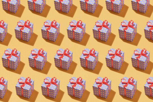 Set of gift boxes with a tape on yellow background.