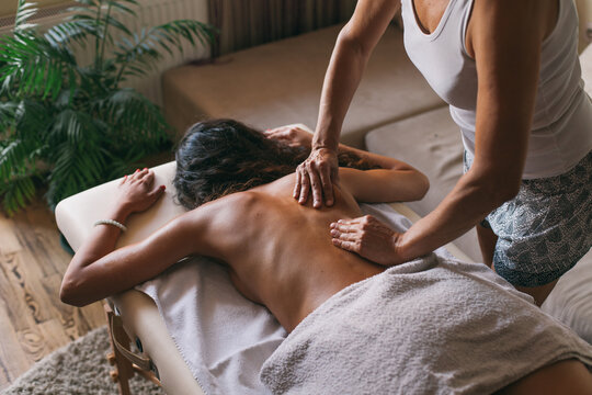 Masseur doing massage of female back