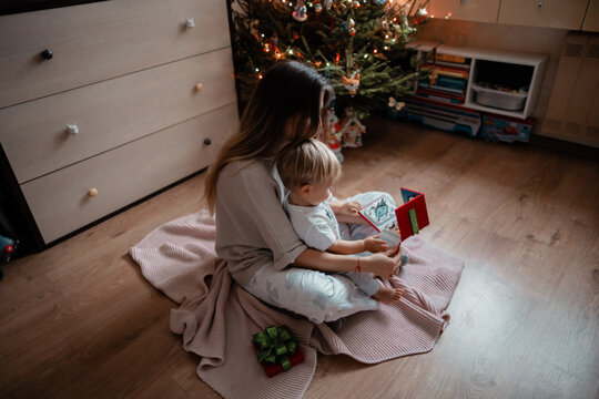 Mom and little son looking at the book