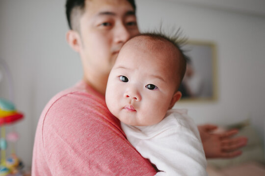 portrait of father with baby at home