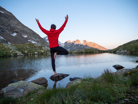 Yoga at peaceful alpine lake