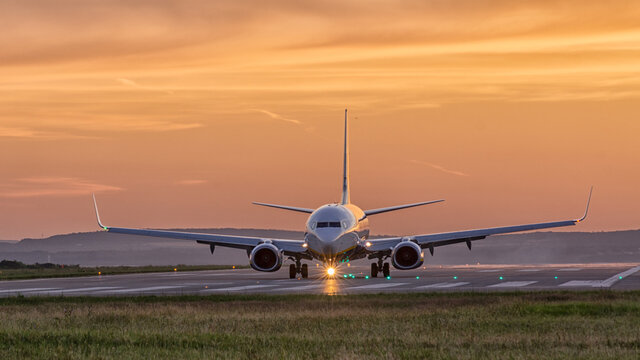 airplane landing at sunset Varna Airport - Powered by Adobe