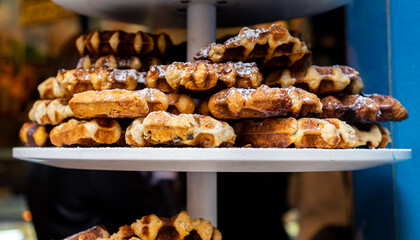 Viennese waffles on a tray on a shop window of a pastry shop.