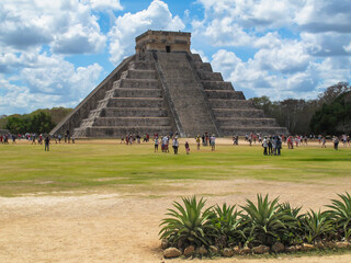 Tourist visiting Temple of Kukulcan in the archaeological site of Chichen Itza,Yuacatan, Mexico.Famous Maya city and pyramid.One of the most visited archaeological sites in Mexico.UNESCO site