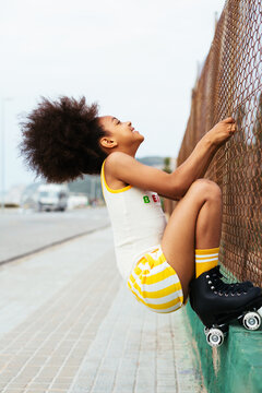 Cute afro girl with rollerblades.