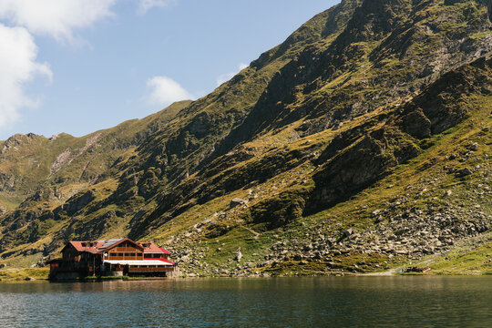 wooden house in front of a lake. Rumanian landscape