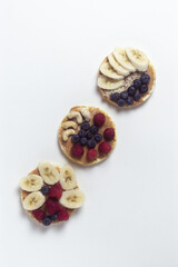 Flat lay  healthy sandwiches with banana and berries