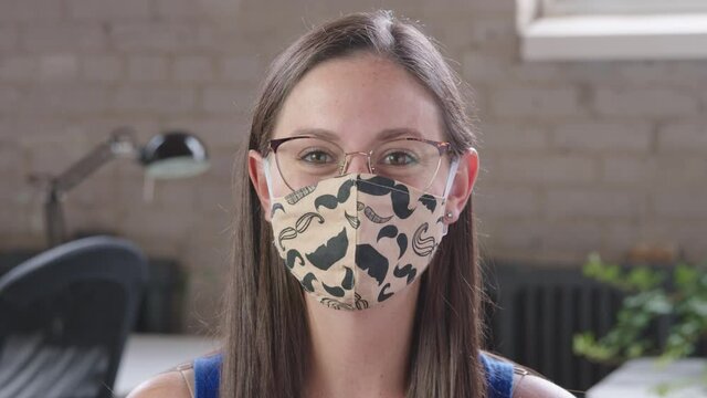 A young caucasian woman putting on surgical mask for corona virus prevention