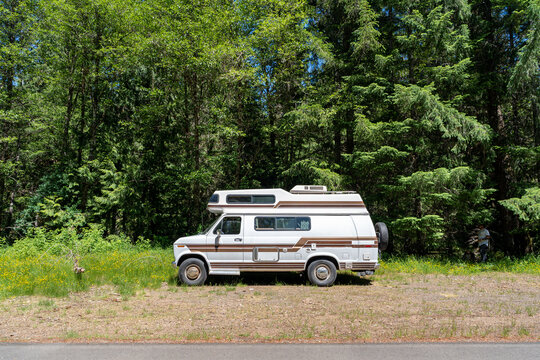 A wide shot of a camper van parked off of the road