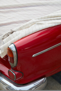 Bright Red Car Covered With Cloth