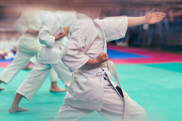 Kids training on karate-do.  Photo without faces. Imitation of film photography.