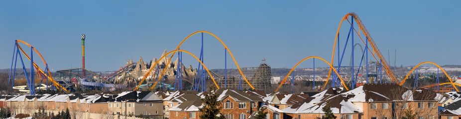 Panorama of a closed amusement park in winter next to a residential housing development near Toronto