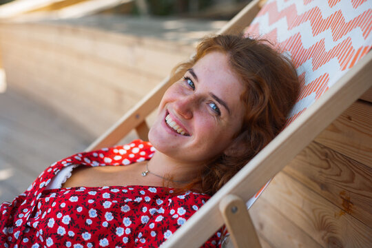 beautiful girl lies on a cot and laughs
