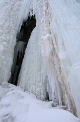 Abstract wall of ice with icicles and snow on the cliff at Tiffany Falls Ontario