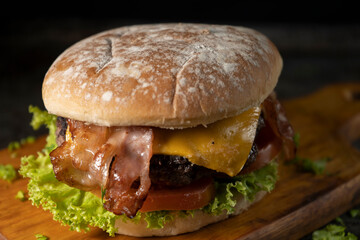 Tasty burger on rustic background