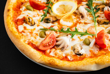 seafood pizza on the black background