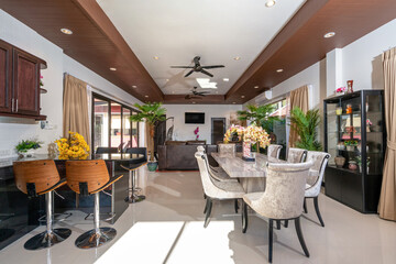 Interior design of house, home, villa, feature dining table, chairs, cabinet, refrigerator with a garden view from kitchen