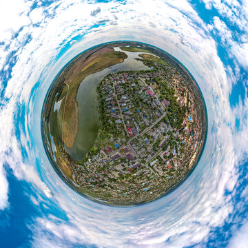over the streets and houses Bryukhovetskaya stanitsa near the river Levy Beysuzhek - aerial small planet panorama on a sultry summer day