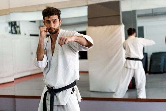 Man Practicing Karate In The Studio.