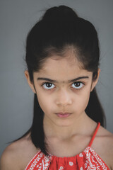 School age girl of British Indian descent displays different facial expressions.