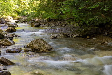 Naklejka na ściany i meble Endless stream. Fast mountain river