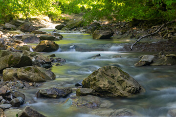 Fototapeta na wymiar Endless stream. Fast mountain river
