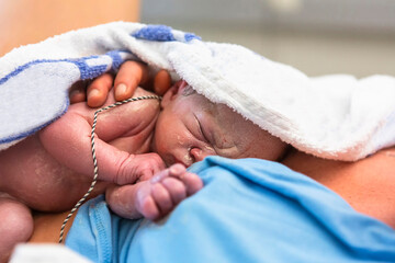 New born baby being treated just after the birth.