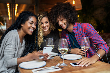 Multiethnic friends group using mobile phone