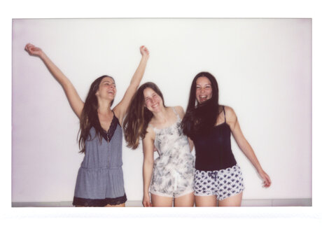 Three women wearing pajamas having fun.