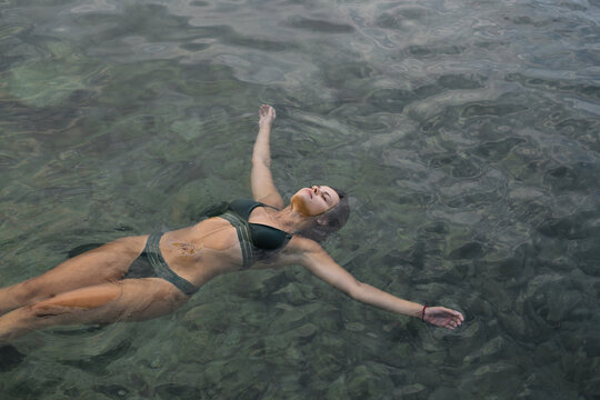 Woman floats in the sea