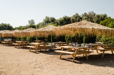 Reed umbrellas on the beach of the island of Lihada-Greece 