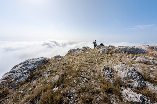 Guy packing his parachute on mountain summit