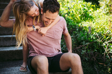 Fun loving dad playing with daughter outside.