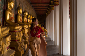 Asian woman visiting a temple in Thailand