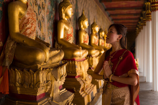 Asian woman visiting a temple in Thailand