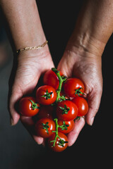 Woman showing cherry tomatoes
