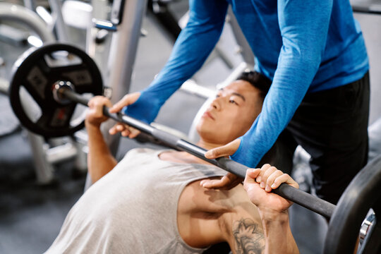 Young asian man training at the gym.