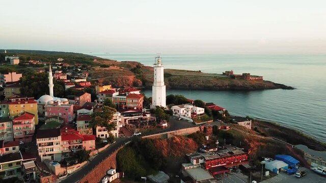 Rumelian Lighthouse, Garipce Village in the early morning. Aerial. A ruined historic fortress with tower built by Genoese some 550 years ago is situated on a hill south of the village
