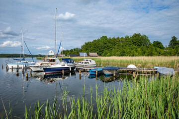 jetty with boats at Lake Krakow in the Mecklenburg Lake District, Germany