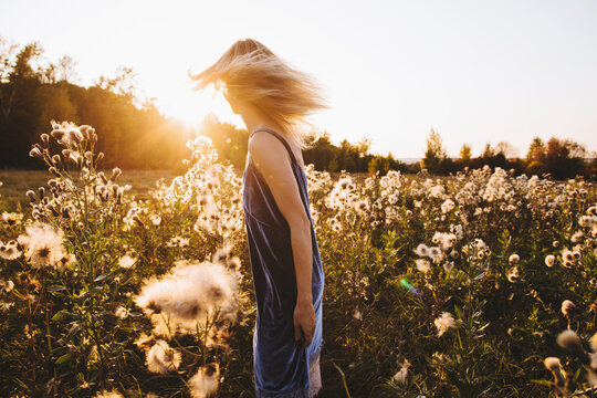 Carefree woman walking at sunset