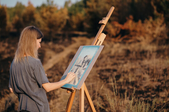 Woman drawing in autumn countryside