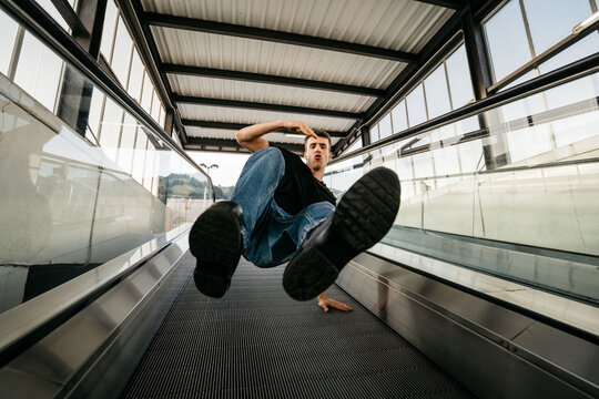 A hip-hop dancer doing breakdance at mechanic stairs
