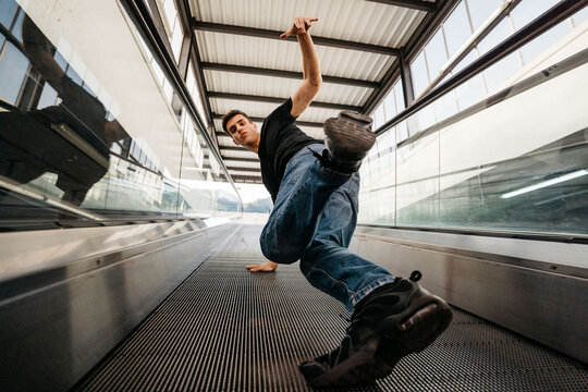 A hip-hop dancer doing breakdance at mechanic stairs