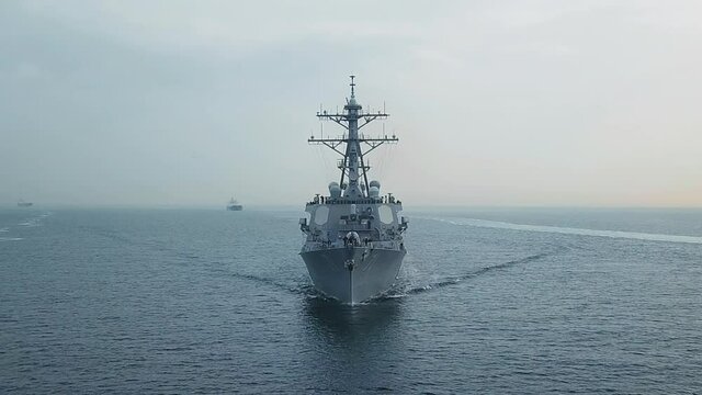 Bow and front deck of guided missile destroyer on ride. Aerial frontal view as the warship ploughs through waters