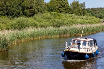 motorboat on the river Elde in the Mecklenburg Lake District, Germany